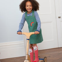 Load image into Gallery viewer, Girl in rainbow pinafore