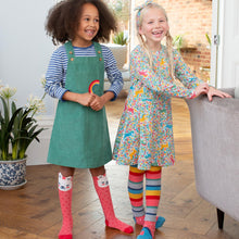 Load image into Gallery viewer, Girl in rainbow pinafore
